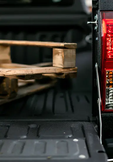 Cargo sliding on unprotected truck bed surface damaging both the box and equipment